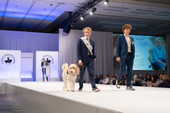 Alex, with Sadie, his diabetic alert service dog, on the runway at the Children’s Diabetes Foundation Brass Ring Luncheon in 2023.