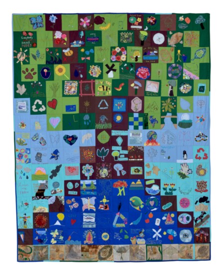 One of the March Quilts, "Environmental Justice," with blocks sewn together by Sew-Op members to depict a tree in a healthy environment.