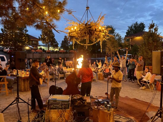 Conner Bennett & Friends (BAM) perform around the Campfire Hotel fire pit.