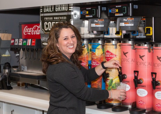 Owner Kori Langford fills a drink at the coffee and tea bar.