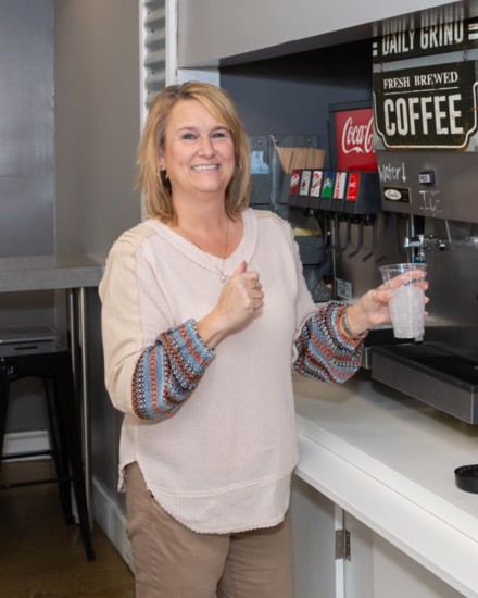 Julie White fills a drink at the coffee and tea bar.