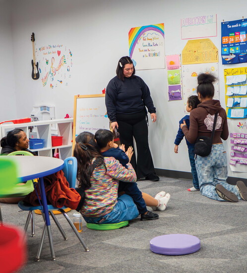 Lead Behavior Technician Edith Dinarte smiles at a child as she facilitates a group session.