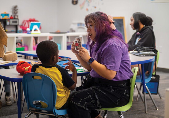 Behavior Technician Lovely Matias works one-on-one with a child during a learning activity. 
