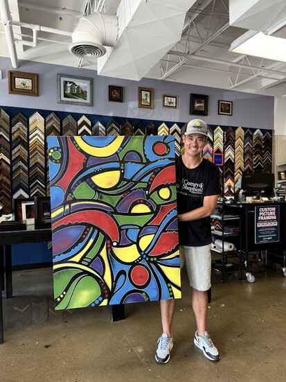 David Uy with one of his vivid fine art pieces.