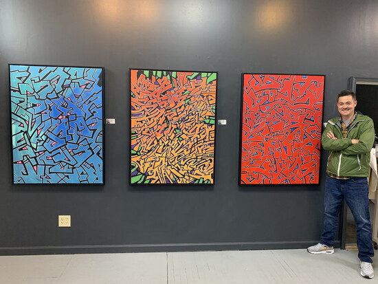 David with three of his fine art paintings at Pop Revolution in Mason. 