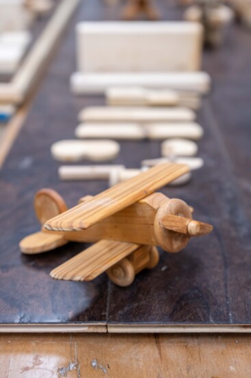 A wooden plane is one of the toys made for kids.