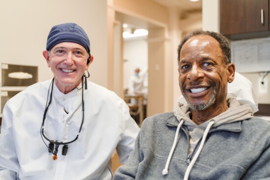 Dr. Craig Goldin with a beaming patient