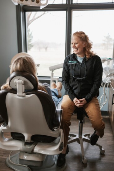 Dr. Kami Marr enjoying a laugh with a patient improving her own smile!