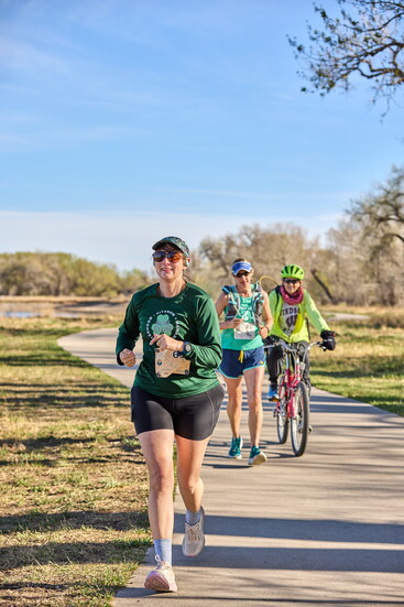 Laura Hiebenthal crushes her miles while her pacers ride close behind, bringing the ultimate energy and cheering her all the way to the finish line.