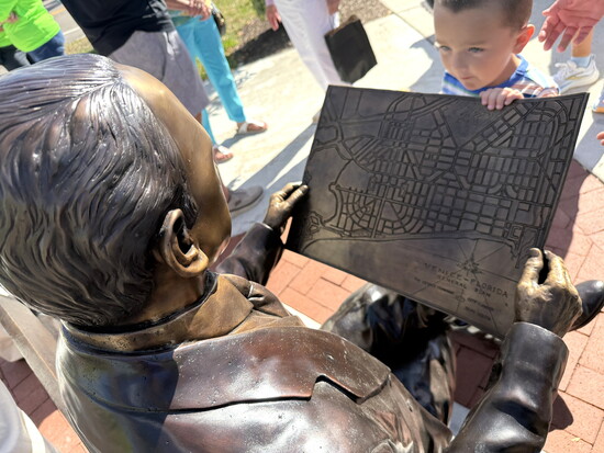 The statue depicts John Nolen holding his urban planning designs. (Photo courtesy City of Venice)