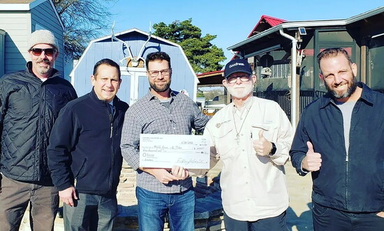 FLDC delivering a check to Community First! Village.