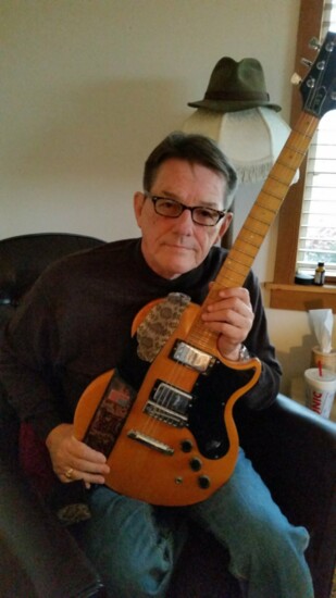 Mike Rabon with his guitar in his later years.