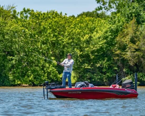 Fishermen look for the perfect spot to hook large bass.