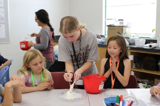 High school students work with their younger peers, all with the hope to spark the career of future teachers.