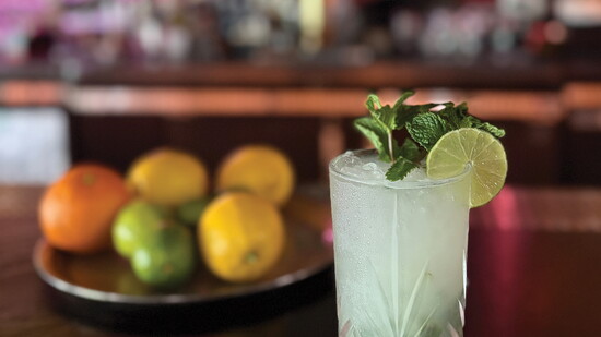 Once Upon a Lime — A Wolf Classic, garnished with fresh basil and a lime wheel, served in an enchanting crystal-cut glass.