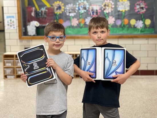 Brothers Joey + Will Hintz enjoy distributing devices to help students with low vision.