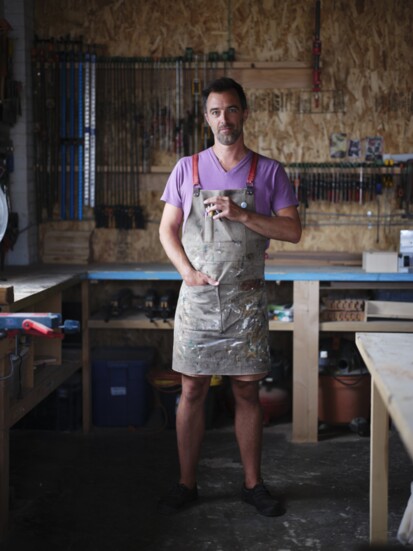 Matthew Shaw, founder and workshop manager poses in wood shop