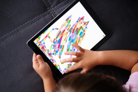 Assistive devices are often used. This child is learning to touch the device first, then can graduate to more involved programs.. 