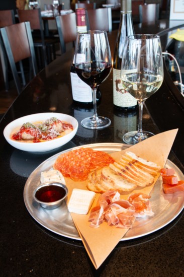 A salumi and cheese plate and a glass of wine at Enoteca Emilia makes a great start to a wonderful dining experience. 