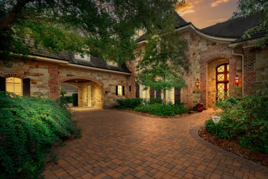 The circular drive leads to an oversized 4 car garage and porte-chochere.