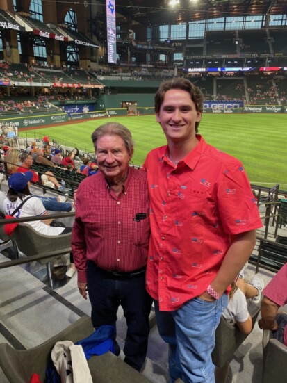 It's a family affair: Mike watching a Rangers game with grandson Will Moore.