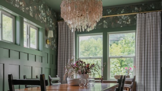 Traditional wainscoting in bold color with traditional style rug, floral wallpaper and plain drapery.(Courtesy of Katie Broden. Photo by Andrew LaFrance)