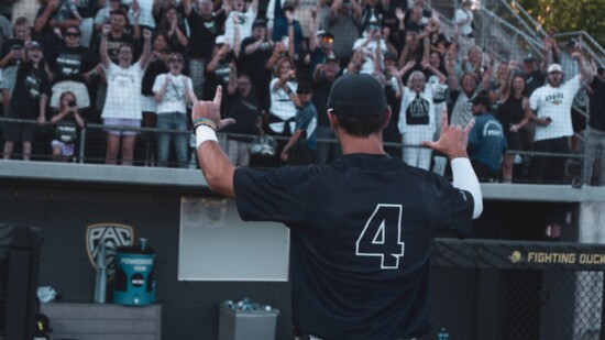 Jake McMurray celebrating with fans after ORU wins Euguene Super Regional