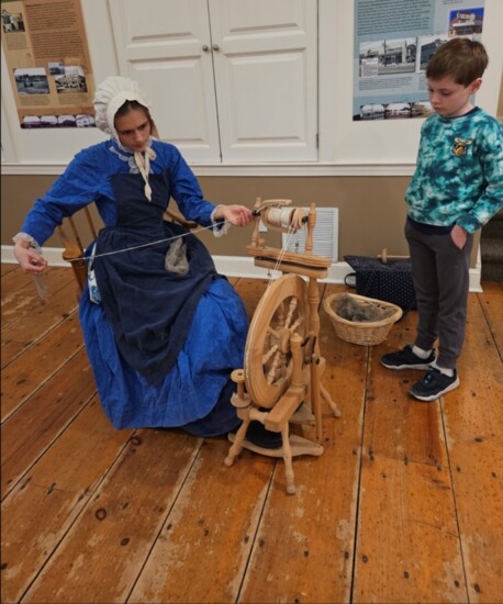 A re-enactor demonstrates the 18th Century art of weaving at the Noah Webster House. 