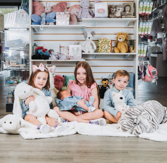 Surrounded by legendary brand Jellycat, the kids cuddle animals galore.