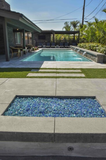 Living the So Cal lifestyle: new pool and blue glass fire pit stones. 
