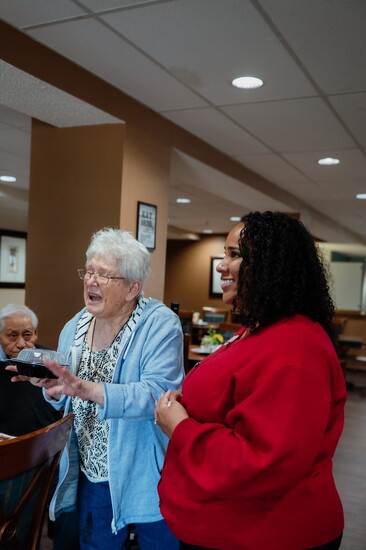 Jasmine Banks shares a laugh with a Tradition resident.