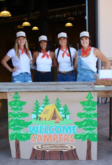 Behind every packed bag is a team with a massive heart. Here, four of WOW's five board members welcome campers to Camp Pack-A-Pack.