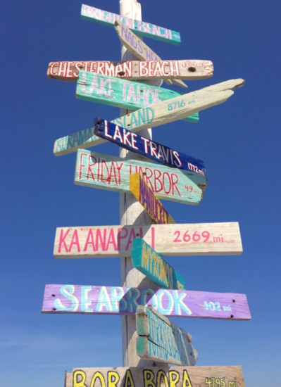 A directional sign provides a fun change of scenery, featuring dream beach destinations from around the world.