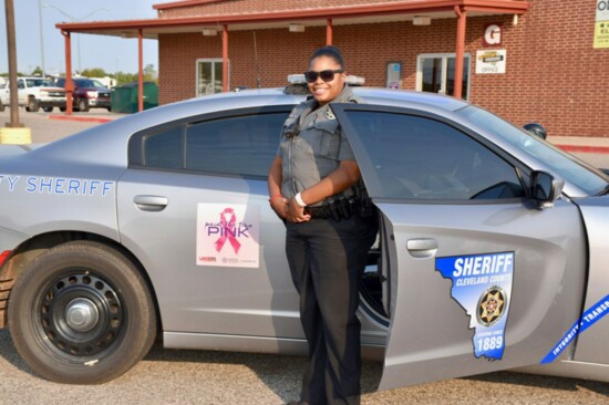 Deputy Saysha Cornish with vehicle sporting a Paint the Town Pink magnet