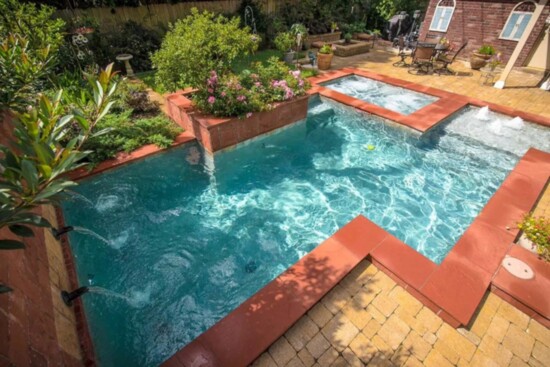 Small back yard? This work of art contains fountains, pool and hottub in one compact space.