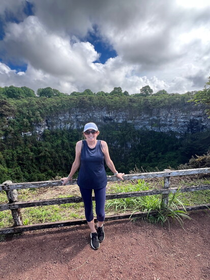 The author poses in front of Los Gemelos sink holes (up to one mile in diameter and approximately 1000 feet deep).