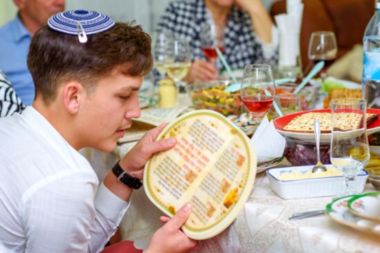 Jewish families celebrate Passover Seder reading the Haggadah.
