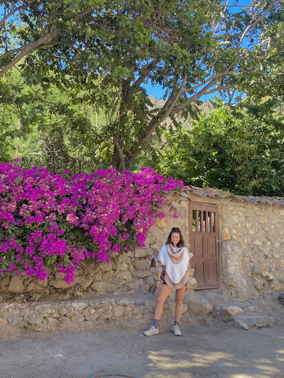 Gia, surrounded by the vibrant Bougainvilleas of her grandmother’s home in Ayacucho, Peru.