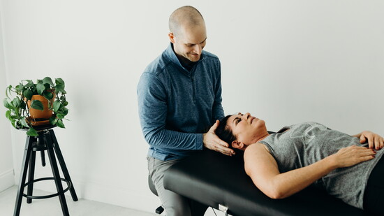 Jason Racca, owner of R3 Physio, working with patient. 