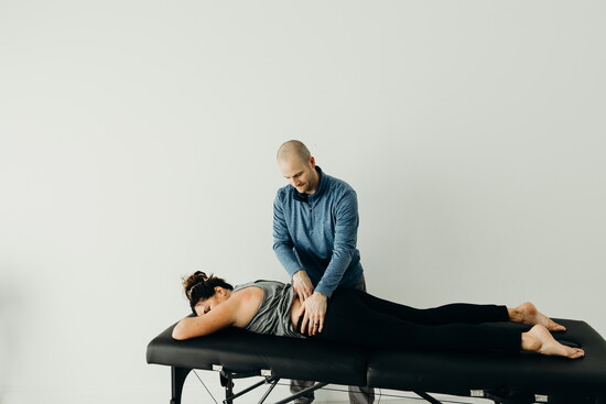 Jason Racca, owner of R3 Physio, working with patient. 