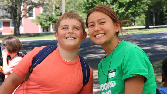 A camper & a volunteer pose for a photo at Summer Day Camp at the Given campus in Indian Hill.