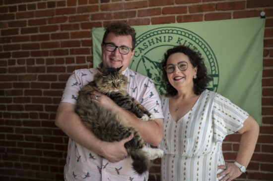 Stuart and Beverly McDaniel cuddle CASHnip Kitty at their agency offices on Third Street in Tulsa.