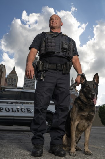 Sworn to protect and serve, Officer Chad Murtaugh and K9 Riggs stand ready in front of Tulsa's skyline.