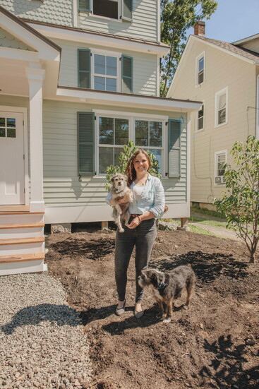 Dr. Masha Kremerman-Waltz with her dogs, Flower and Bart, standing in front of newly opened Pawpaw Tree Veterinary Clinic