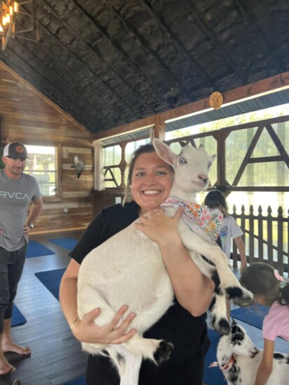 Kelly Cosentino cuddles a goat at goat yoga