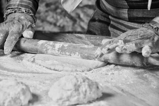 Fresh dough takes shape by hand, a tradition rooted in generations of Italian pizza making.