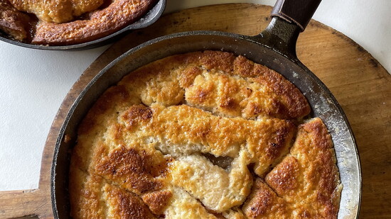 Fresh Fredericksburg peaches bake beneath a golden cast iron crust in Chef Leo's warm summer cobbler.