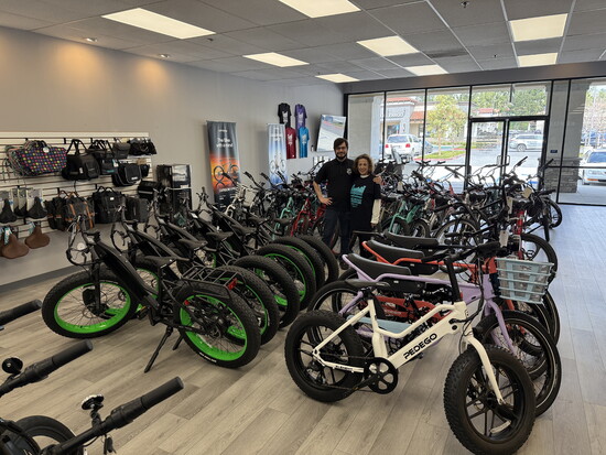 Cheryl and Jodi with huge assortment of electric bikes