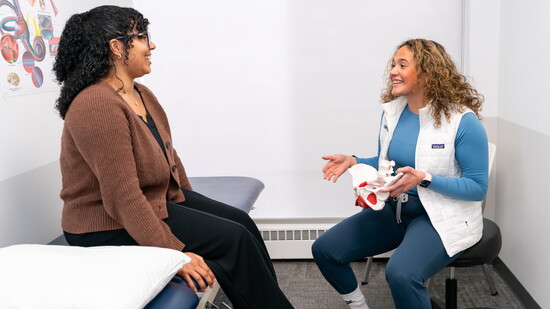 Lauren Cummins works with a patient at FYZICAL