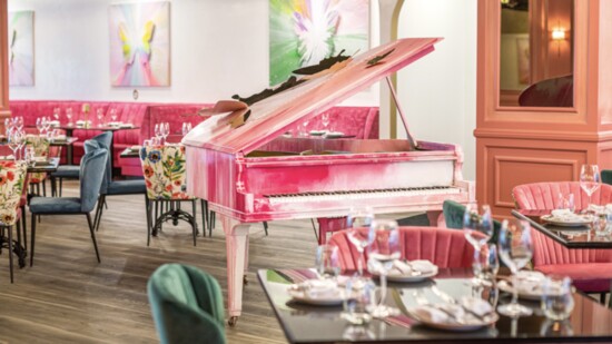 A hand-painted grand piano is the focal point of the main dining room.